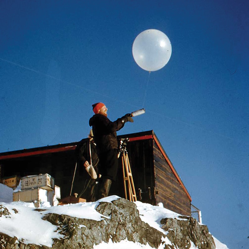 <p>A weather balloon being launched at Base F, Argentine Islands (Credit: Pete Kennett/BAS Archives)</p>
